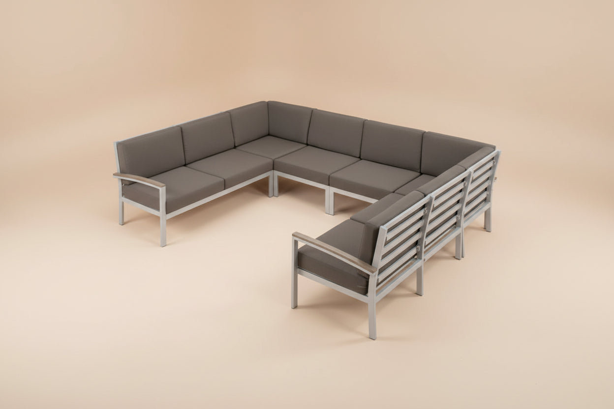 L-shaped outdoor patio sectional sofa with dark gray cushions and a silver metal frame, shown on a plain white background.